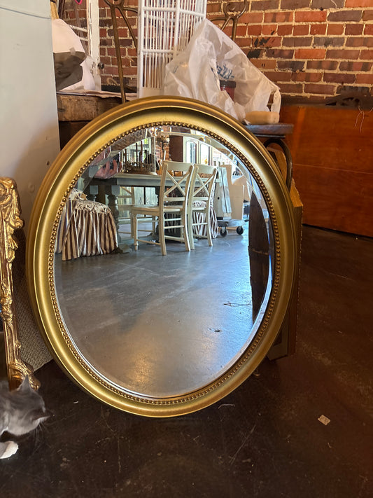 Gold oval mirror